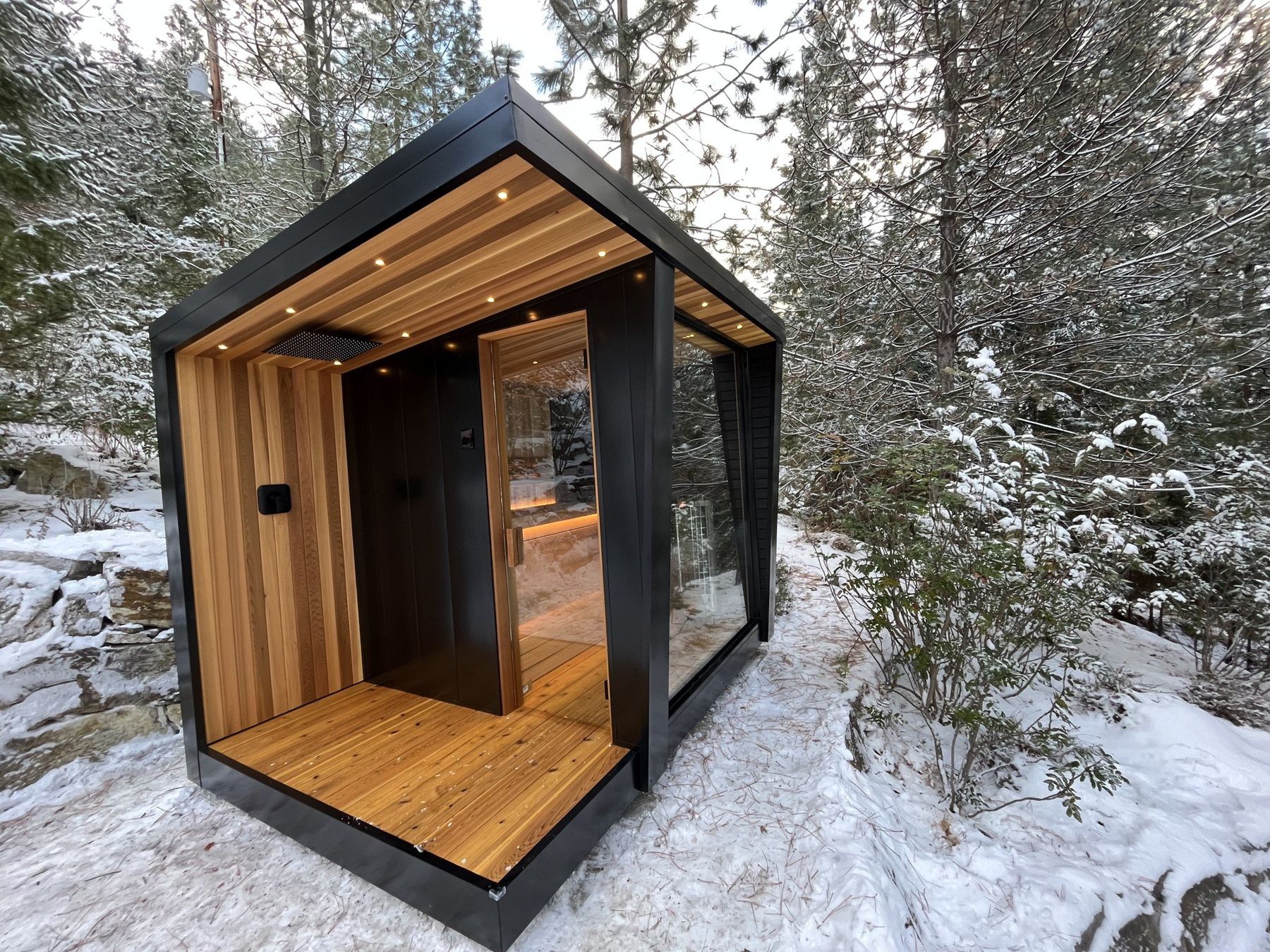 Outdoor cedar sauna with lighting