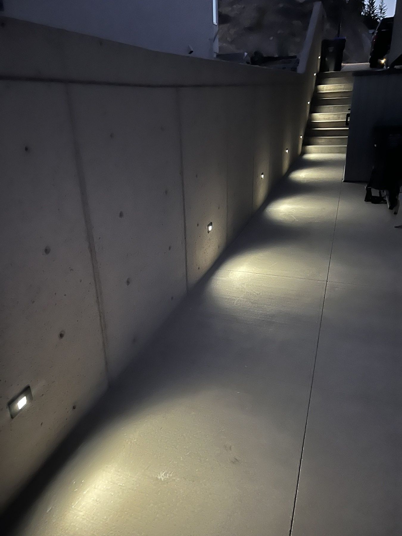 Lit concrete walkway at night